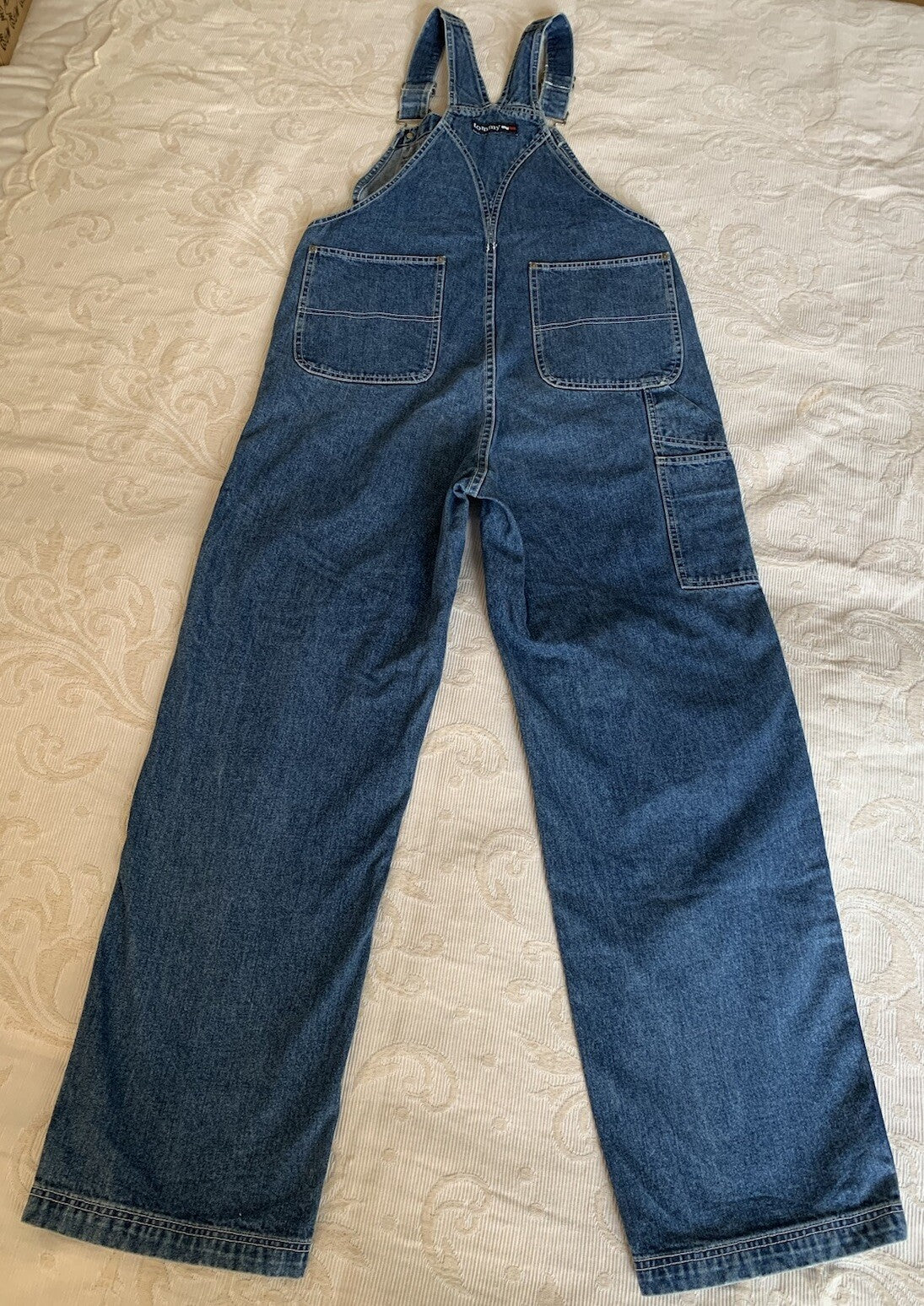 Rückansicht einer blauen Tommy Hilfiger Latzhose mit Logo am Rücken